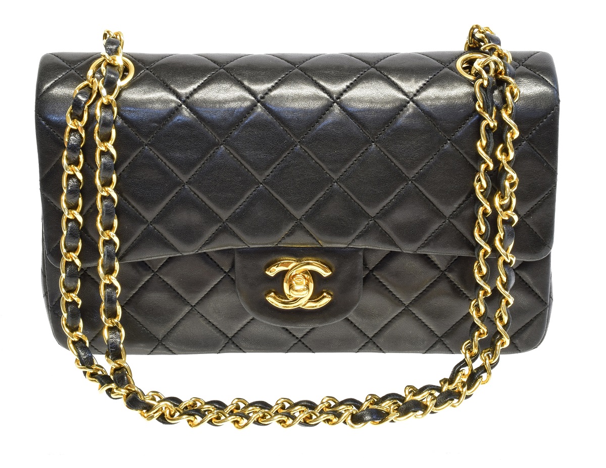 A Chanel Classic Double Flap Bag, circa 1989-91, the black quilted leather exterior with gold-tone hardware and chain handles, serial no. 1601799, with maker's authenticity card. 23x15x6.8cm Sold for £3,538