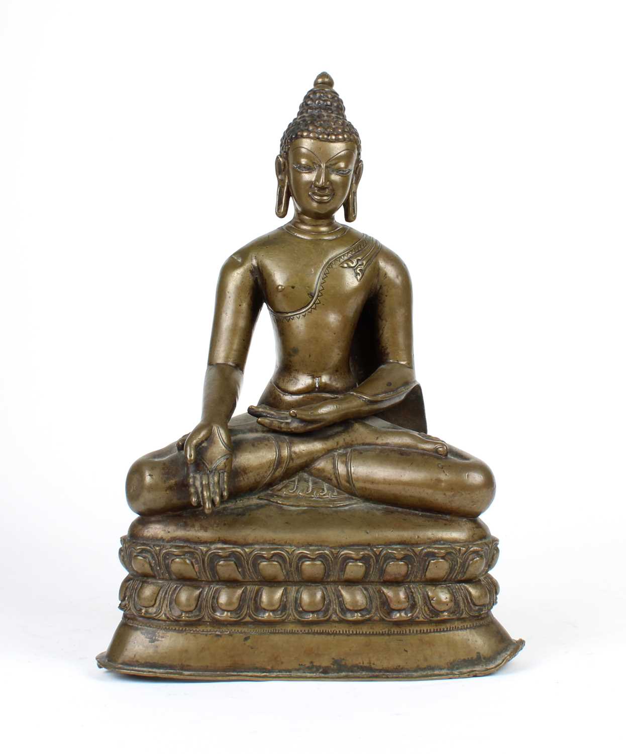 A bronze Buddha statue seated in a meditative pose against a plain white background.