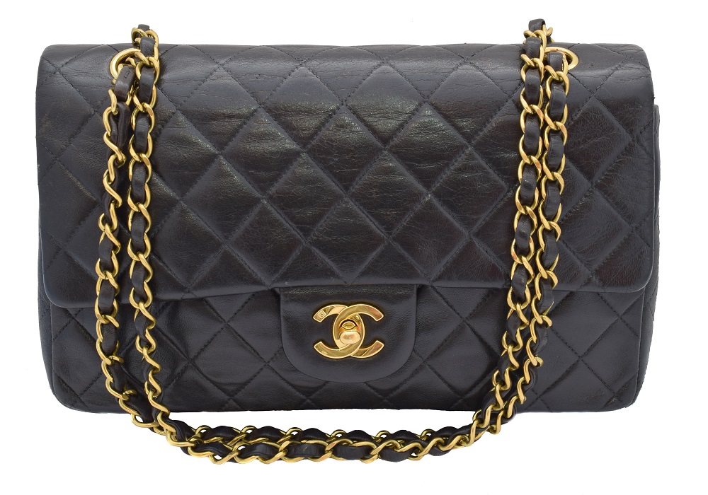 A Chanel Classic Double Flap Handbag, circa 1994 - 1996, the black quilted lambskin leather exterior with gold-tone locking clasp, gold-tone double chain shoulder strap, serial number 3067126. With maker's authenticity card and dust bag. 26x16x7.5cm Sold for £2,928