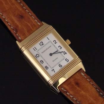 An 18ct gold Jaeger-LeCoultre Reverso wristwatch, circa 1990, the rectangular signed silvered dial with arabic numerals, sapphire glass, turn-over case 22 x 39mm overall, quartz movement, on Jaeger-LeCoultre leather strap. With maker's box and booklet.