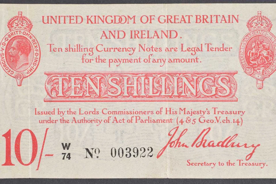  A ten shilling note from the United Kingdom, featuring intricate designs and historical figures.